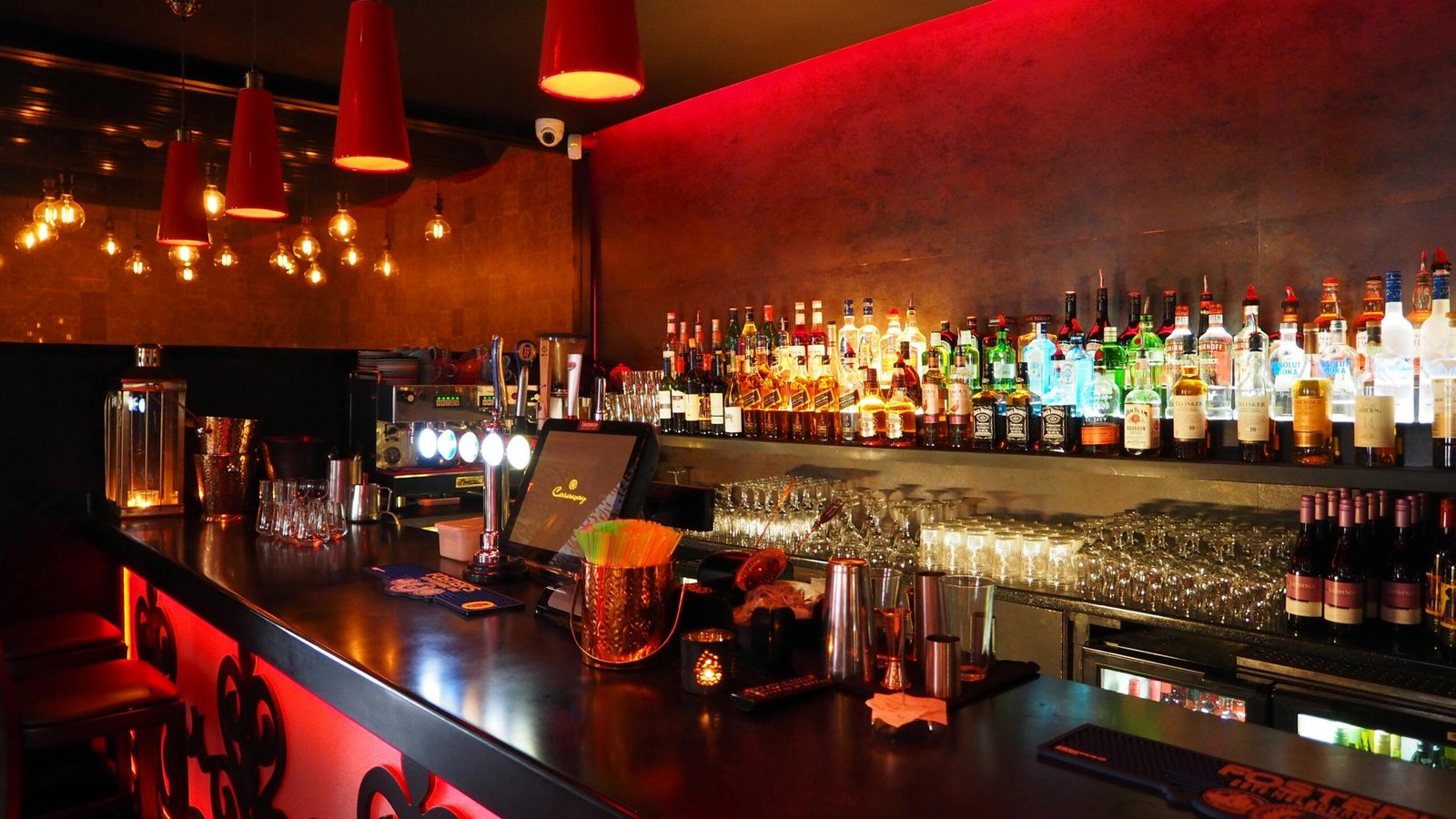 Enjoy the warm ambiance of a well-stocked, illuminated bar perfect for nightlife and celebrations.